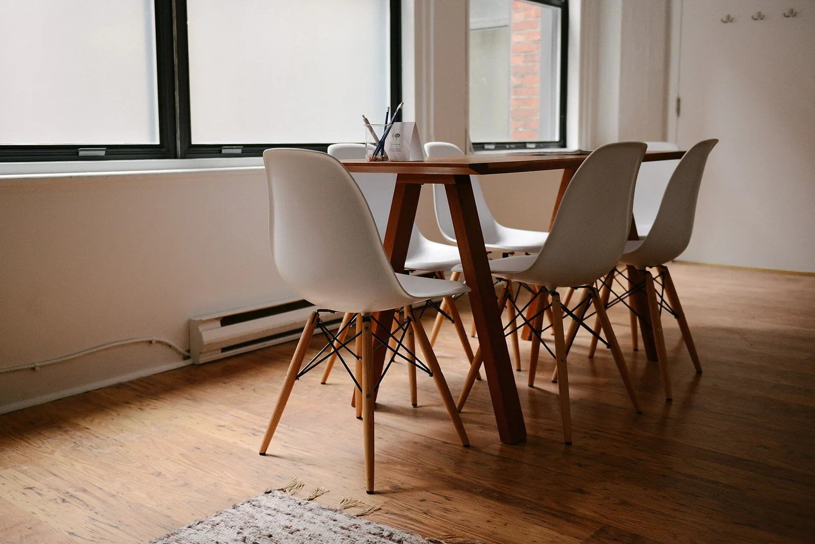 Meeting table with white chairs in a bright office room