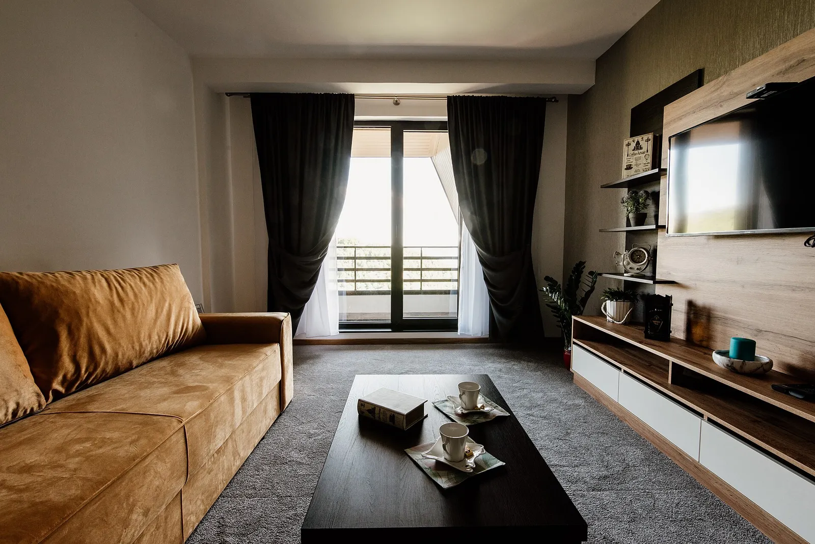 Modern apartment living room with sofa and balcony window