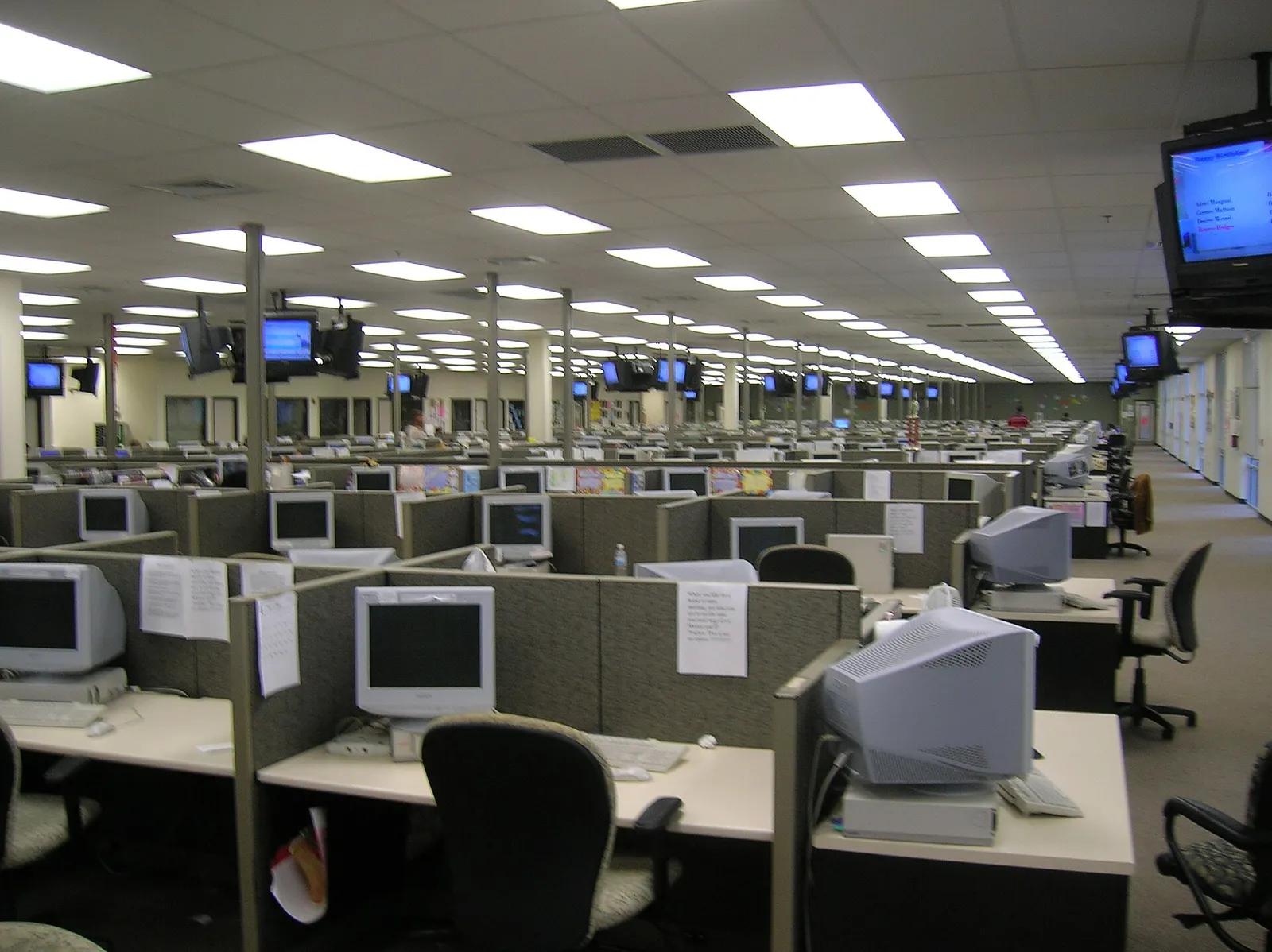 Large call centre floor with rows of desk workstations