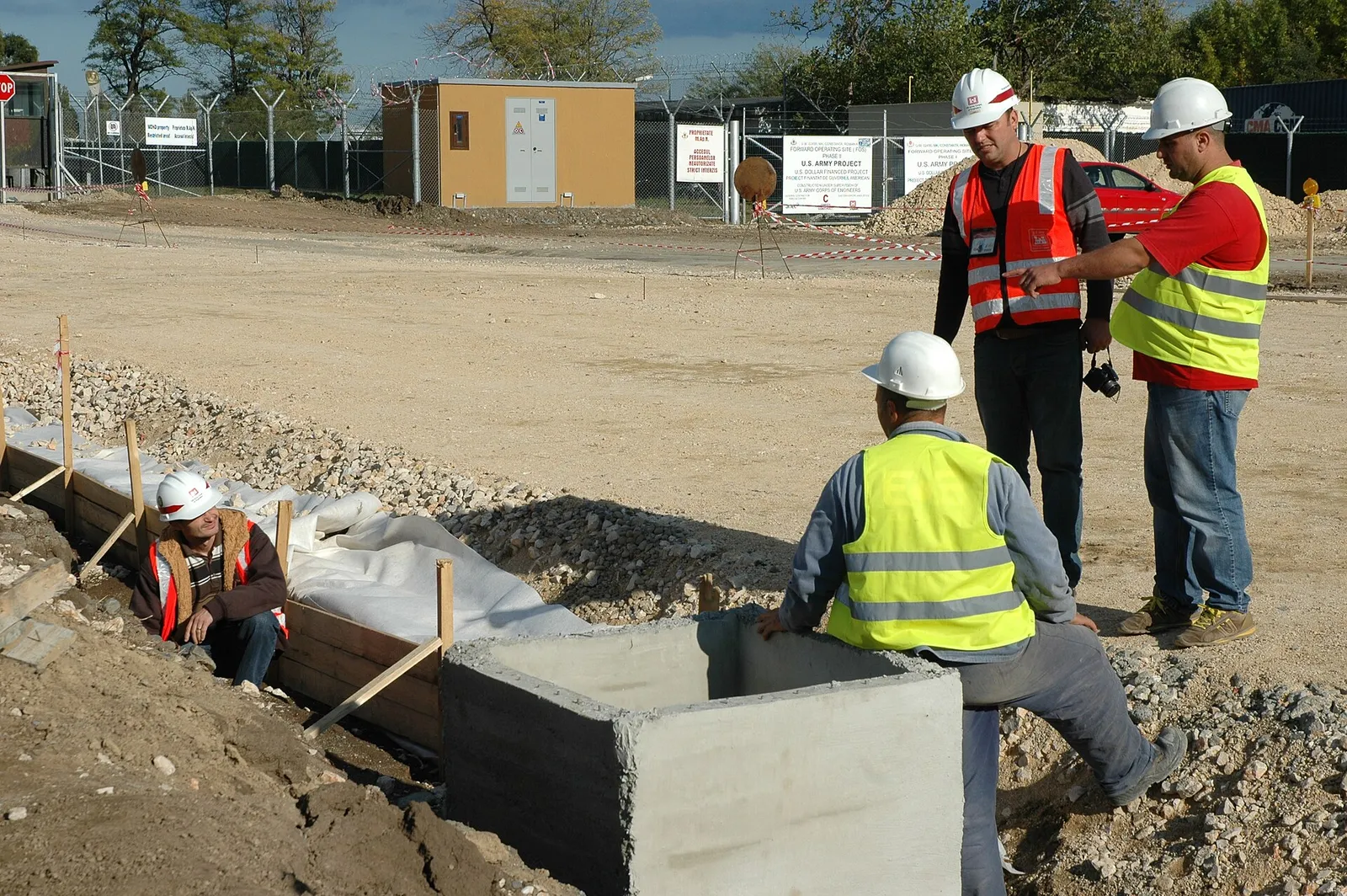 Engineers in hard hats inspecting work on a construction site