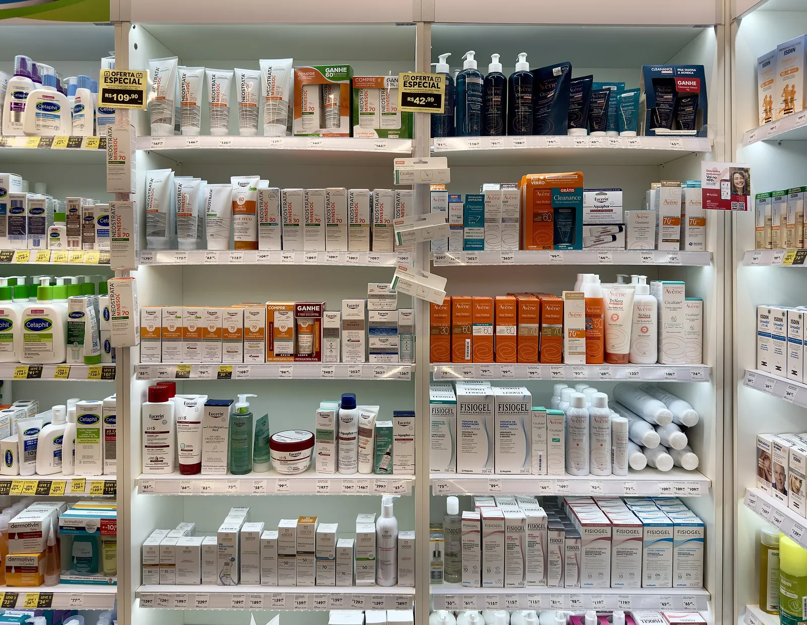Skincare products arranged on white drugstore shelves