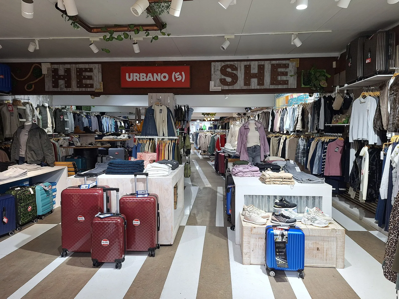 Clothing store interior with garment racks and display tables