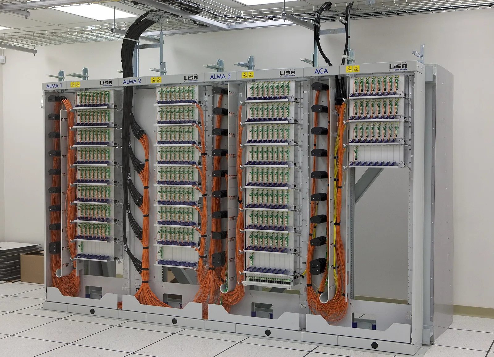 Fibre optic patch panel racks with routed orange cables