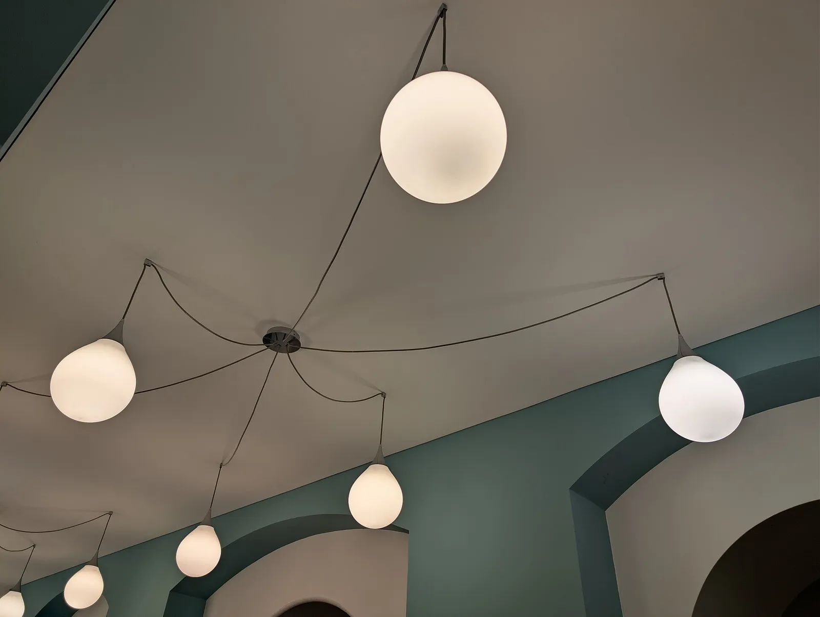 Globe pendant lights hanging from an interior ceiling