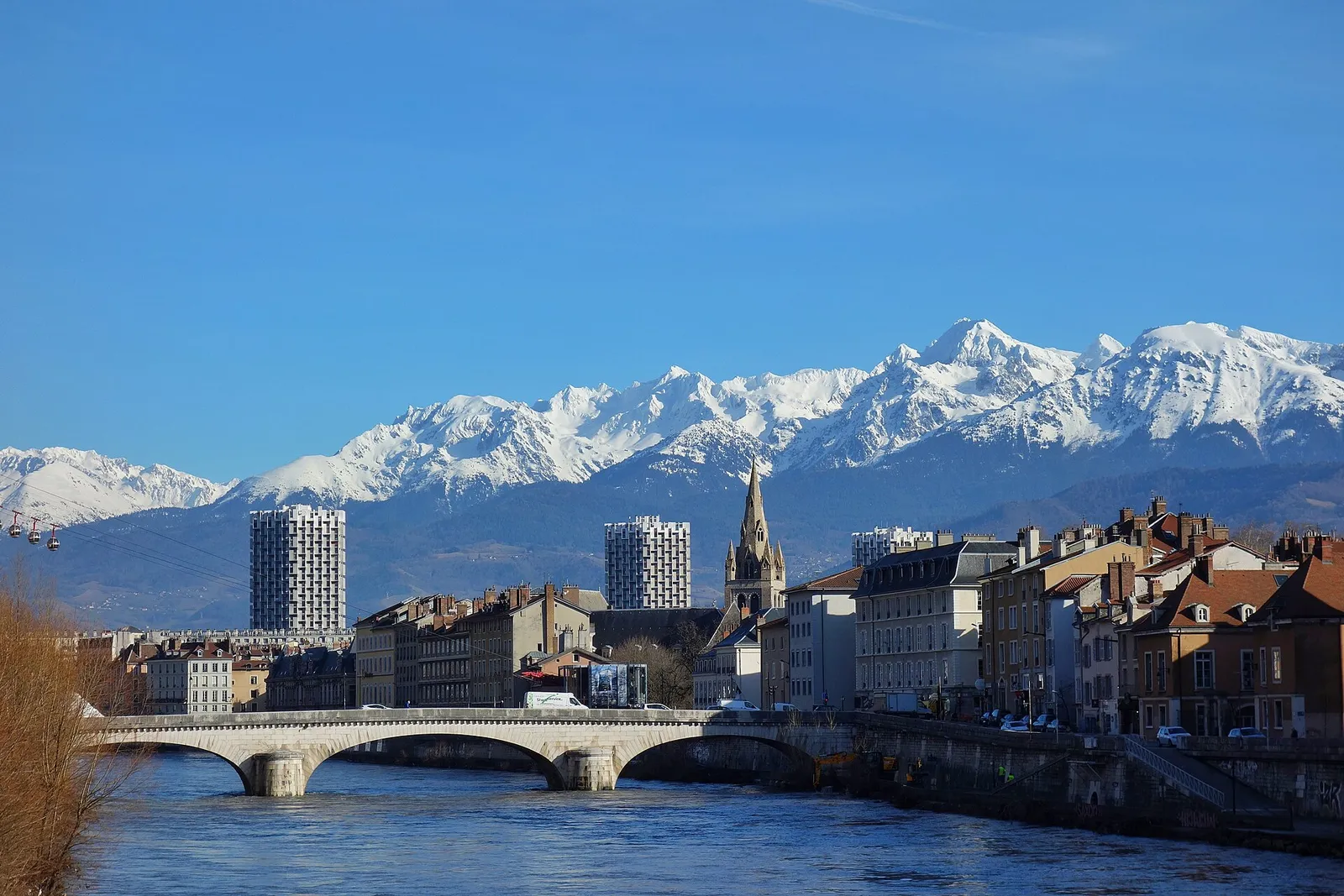 Grenoble and the Isère river with the snow-capped Alps behind