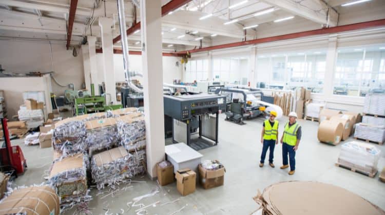 Workers on a paper and packaging factory floor
