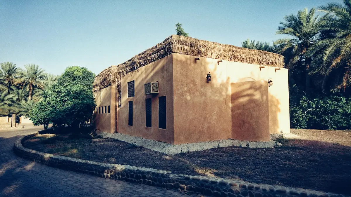 Palm groves and a heritage building in Al Ain Oasis