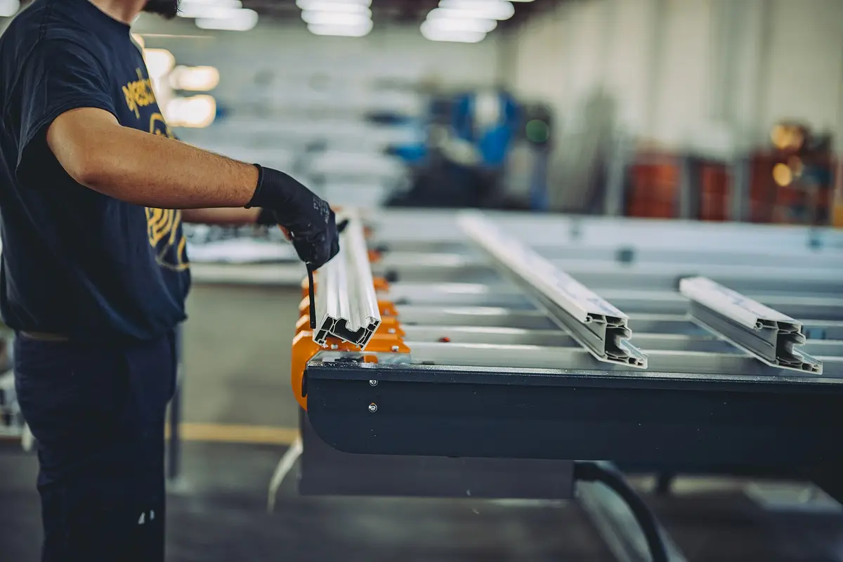 A worker assembling metal parts in a factory